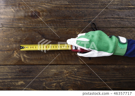tape-measure in a hand tape-measure in a hand 46357717