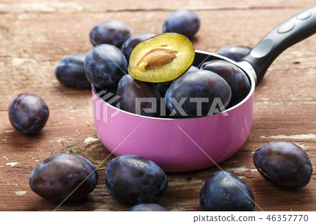 ripe plums in a saucepan ripe plums in a saucepan 46357770