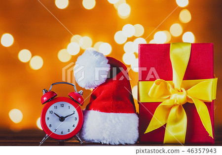 Christmas gift box and Santa Claus hat with red vintage alarm clock 46357943