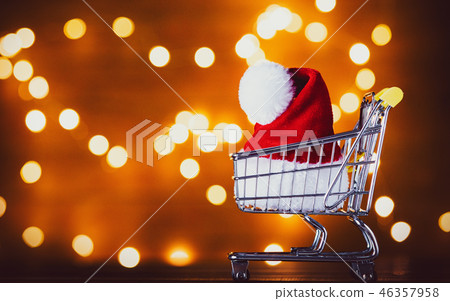 Santa Claus hat in shopping cart and Christmas Lights  46357958