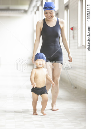 Boys and women walking poolside 46358845