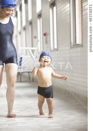 Boys and women walking poolside 46358851