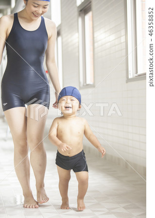 Boys and women walking poolside 46358852