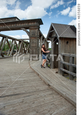 Beauty girl on old-time bridge. Beauty girl on old-time bridge. 46358859