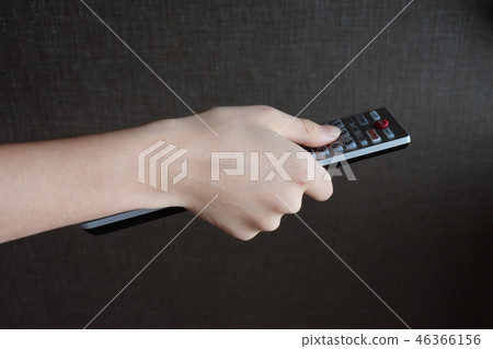 Remote control and hand holding remote control Remote control and hand holding remote control 46366156