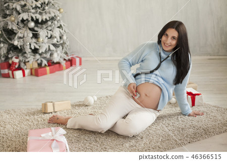 Portrait of beautiful pregnant woman Christmas new year tree gift holiday Portrait of beautiful pregnant woman Christmas new year tree gift holiday 46366515