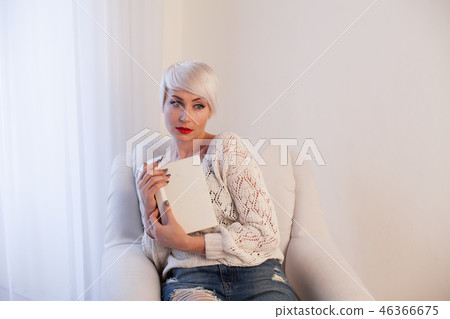 beautiful blonde woman with short book reads book training 46366675