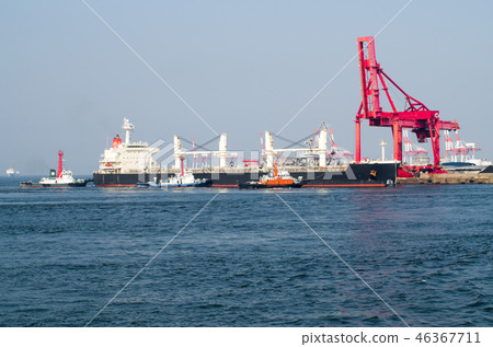 Large cargo ship and tugboats to be docked at the pier Large cargo ship and tugboats to be docked at the pier 46367711