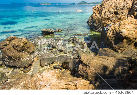 Tropical island rock on the beach with blue sky. 46368664