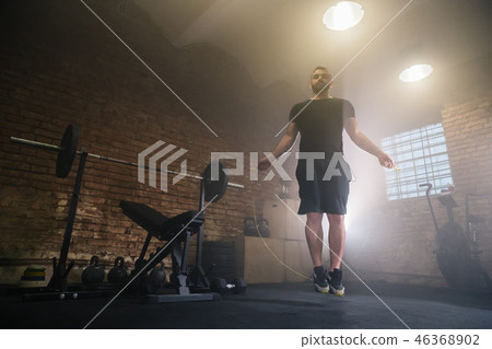 Young man doing hard exercise workout in gym Young man doing hard exercise workout in gym 46368902