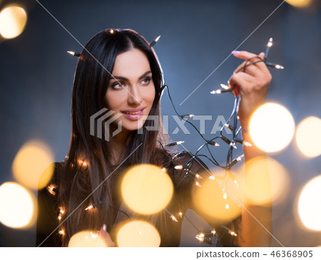 Beautiful dark hair young woman with blur lights Beautiful dark hair young woman with blur lights 46368905