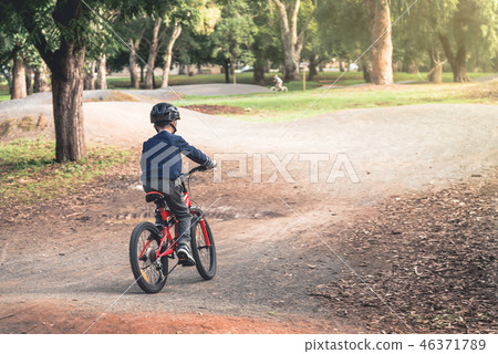 Boy riding his bicycle 46371789