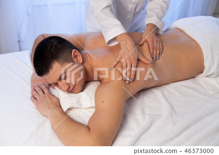 a massage therapist makes therapeutic massage of hands and neck in Spa 46373000