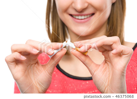 Young woman is breaking a cigarette Young woman is breaking a cigarette 46375068