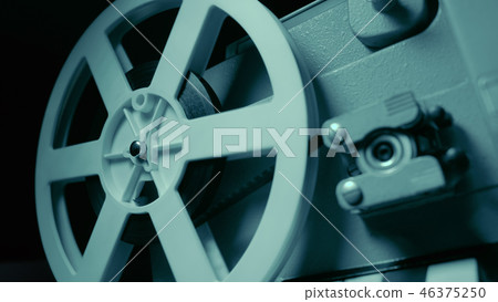 Film projector with dramatic blue lighting and selective focus. Retro film production still life Film projector with dramatic blue lighting and selective focus. Retro film production still life 46375250