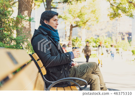 Young men park bench coffee Young men park bench coffee 46375310