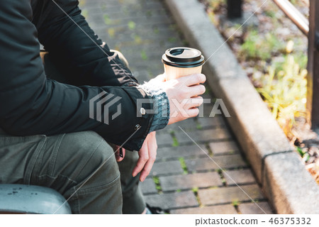 Winter young man drinking coffee outdoor Winter young man drinking coffee outdoor 46375332