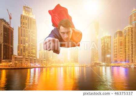 Superhero businessman flying over the city 46375337