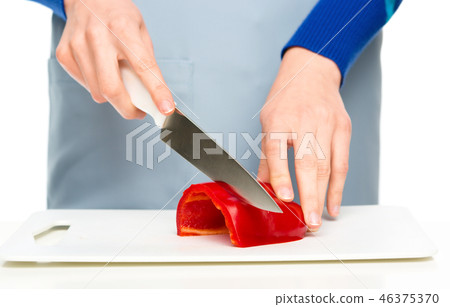 Cook is chopping bell pepper 46375370