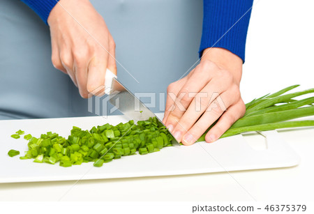 Cook is chopping green onion Cook is chopping green onion 46375379