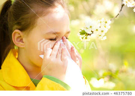 Little girl is blowing her nose 46375780