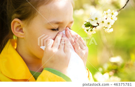 Little girl is blowing her nose 46375781