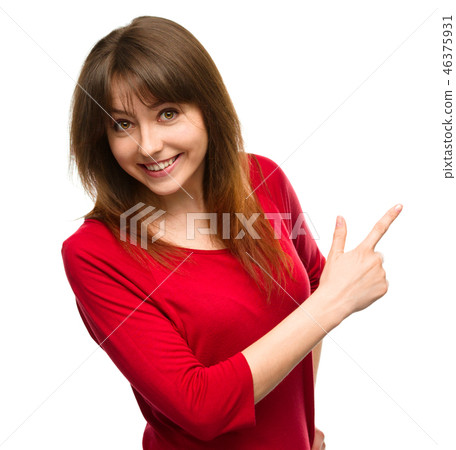 Portrait of a young woman pointing to the right 46375931