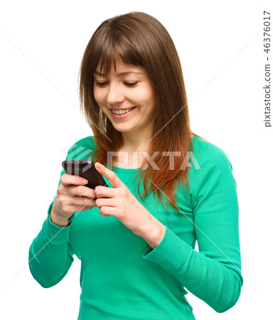 Young woman is typing sms message on her phone 46376017