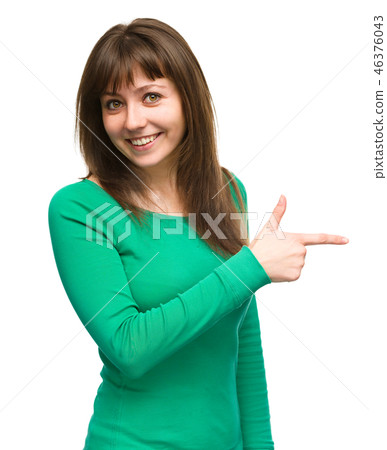 Portrait of a young woman pointing to the right Portrait of a young woman pointing to the right 46376043