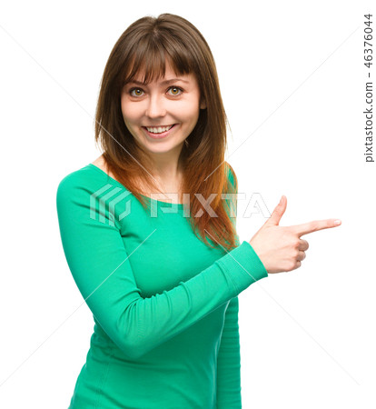 Portrait of a young woman pointing to the right Portrait of a young woman pointing to the right 46376044