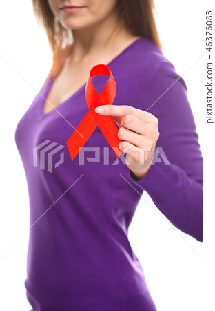 Woman is holding the red awareness ribbon Woman is holding the red awareness ribbon 46376083