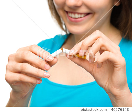 Young woman is breaking a cigarette Young woman is breaking a cigarette 46376148
