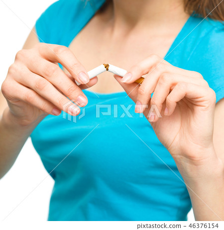 Young woman is breaking a cigarette Young woman is breaking a cigarette 46376154