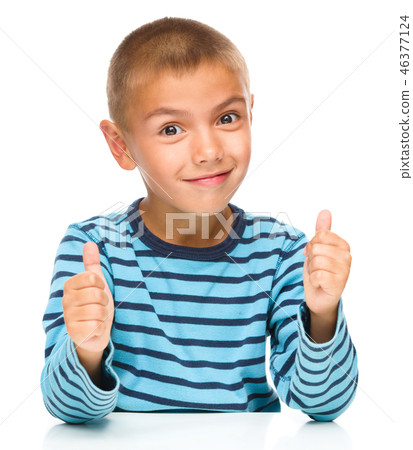 Portrait of a cute boy showing thumb up sign 46377124
