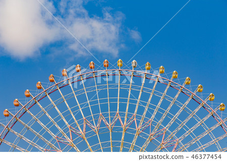 Giant ferris wheel against blue sky Giant ferris wheel against blue sky 46377454