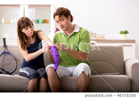 Man and woman discussing elbow strap Man and woman discussing elbow strap 46378188