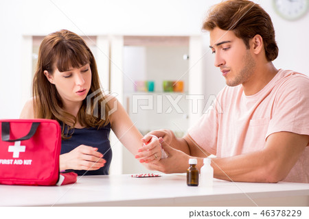 Young family getting treatment with first aid kit 46378229