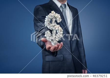 A businessman with unseen face shows an open palm with a dollar sign made of many paper banknotes. A businessman with unseen face shows an open palm with a dollar sign made of many paper banknotes. 46379251