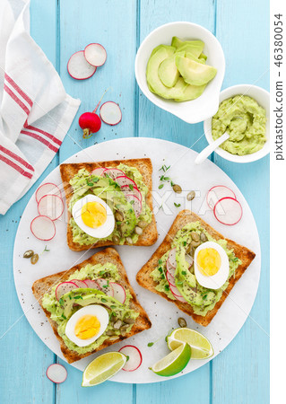Toasts with avocado guacamole, fresh radish 46380054