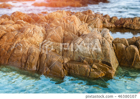 Strange sea stone in the clear saltwater. Strange sea stone in the clear saltwater. 46380107