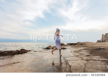 Beautiful running woman near the sea outdoors in the summer Beautiful running woman near the sea outdoors in the summer 46380966