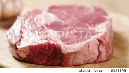 Closeup   of raw rib eye steak on board 46381196