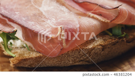 Closeup   of italian sandwich with speck, arugula salad and beer 46381204