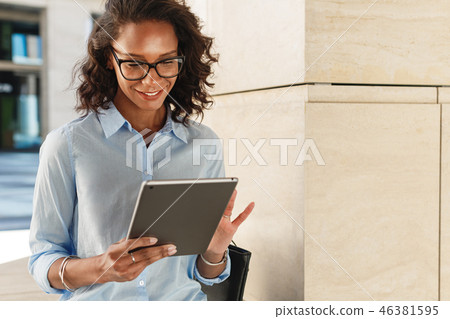 Young woman wearing eyeglasses reading  46381595