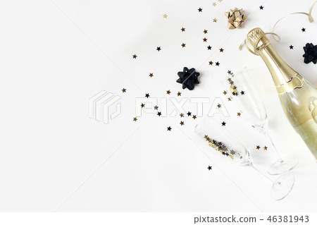 Happy New Year composition. Champagne wine bottle and glasses with golden confetti stars isolated on 46381943