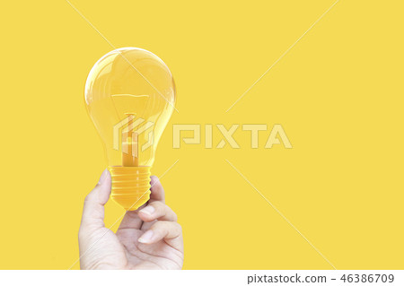 Hand holding light bulb yellow pastel color Hand holding light bulb yellow pastel color 46386709