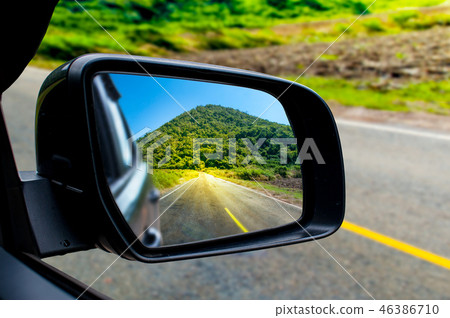 Landscape in the sideview mirror of a car Landscape in the sideview mirror of a car 46386710