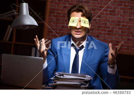 Young businessman working in the office at night Young businessman working in the office at night 46388783