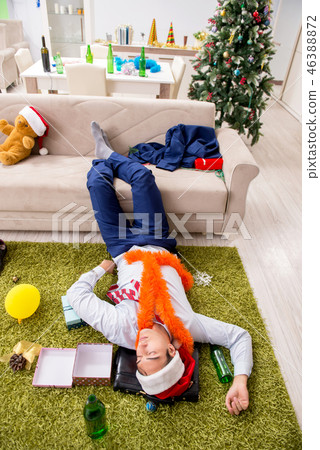 Young handsome employee celebrating Christmas at workplace  46388872