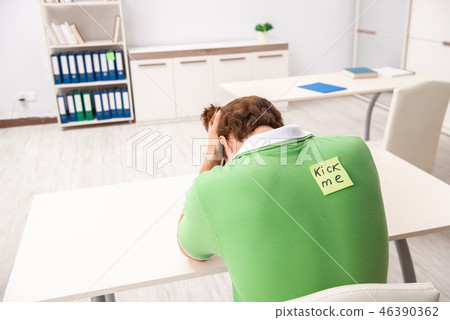 Office prank with kick me message on sticky note 46390362